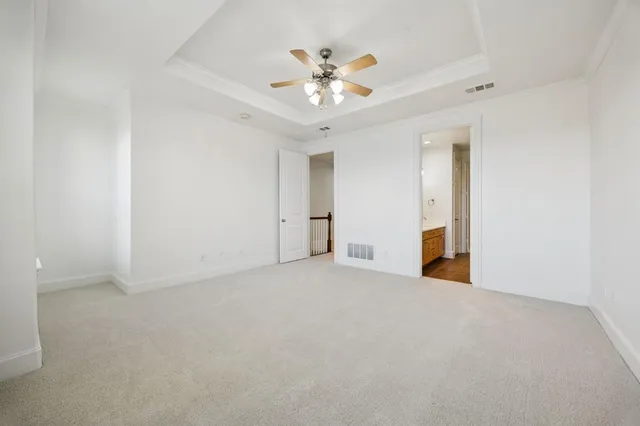 a view of an empty room with a ceiling fan