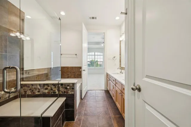 a bathroom with a sink a mirror and a shower