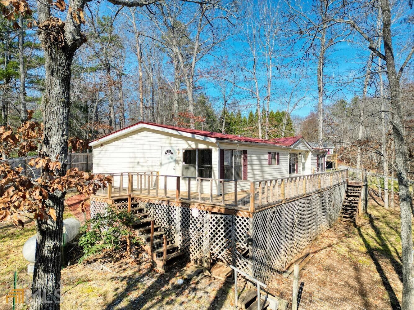 a view of a house with a small yard and wooden fence