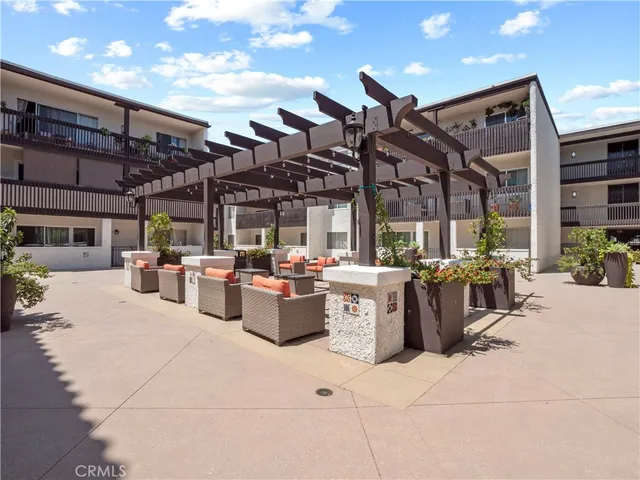 a view of a patio with dining table and chairs with plants