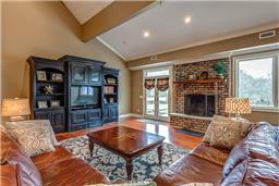 3363 Sweeney Hollow Road Franklin, TN 37064 - Photo 2 of 14 The home displays a very large family room with built in cabinetry and a wood burning fireplace.