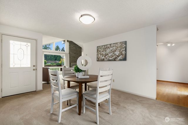 a view of a dining room with furniture and window