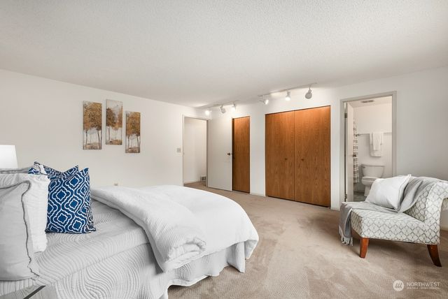 a spacious bedroom with a bed and a couch