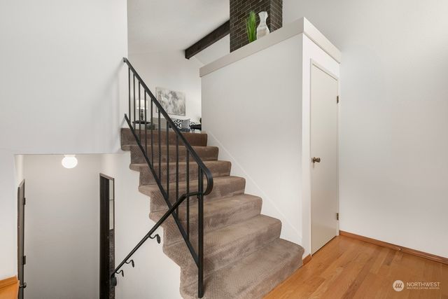 a view of entryway and hall with wooden floor
