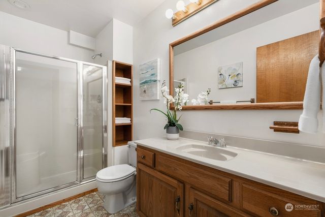 a bathroom with a sink a toilet and shower