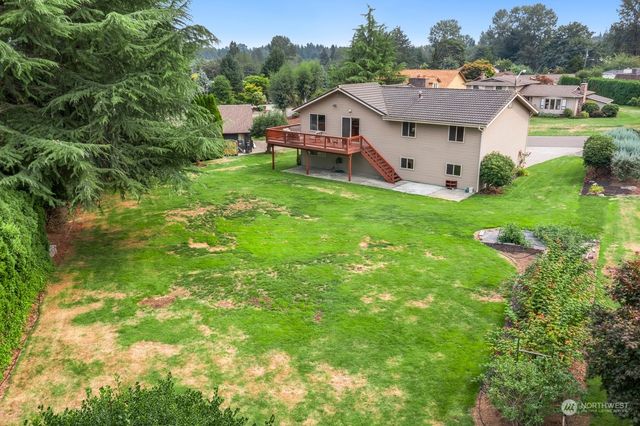 a view of a house with a yard balcony and sitting area