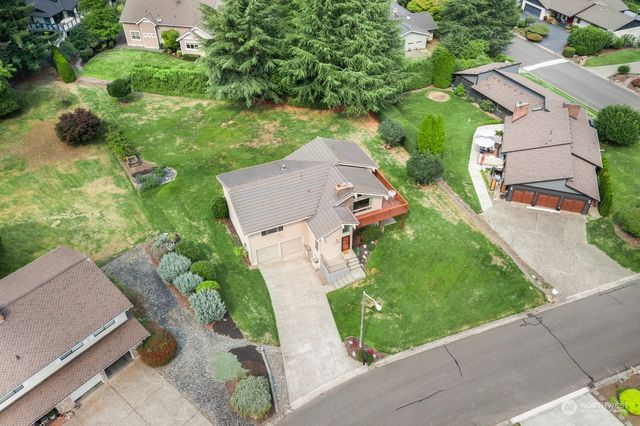 an aerial view of a house with a garden and yard