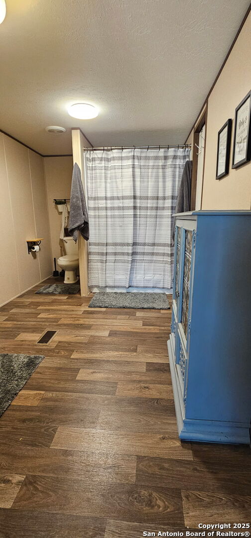 275 W Trail Pleasanton, TX 78064 - Photo 8 of 17 a view of an empty room with wooden floor and a window