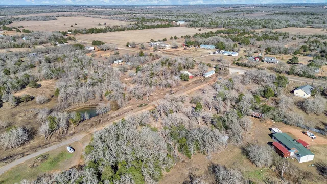 an aerial view of house with yard and ocean view