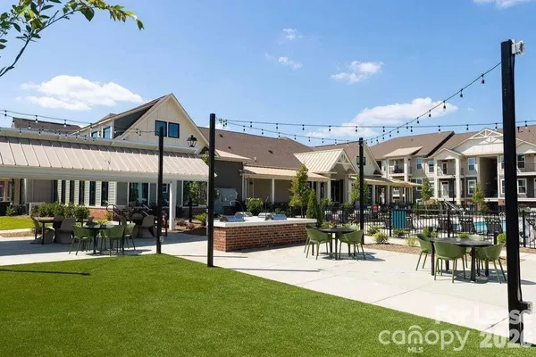 a living room with furniture a fireplace and a floor to ceiling window