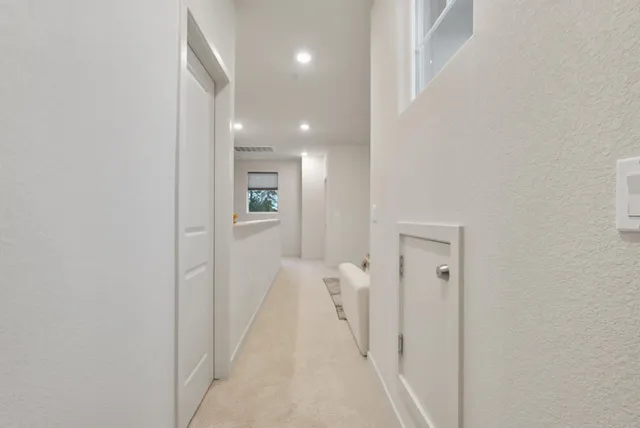 a view of a hallway with wooden shelves