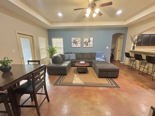 a living room with furniture and a wooden floor