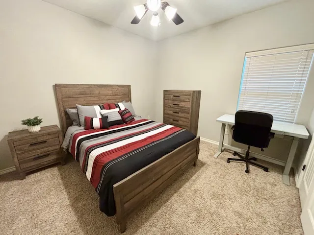 a bedroom with bed and a chair