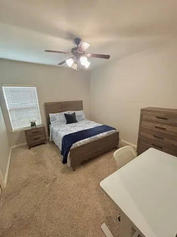 a bedroom with two beds and painting on the wall