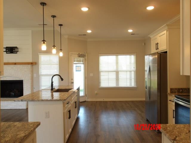 25 Daisy Way Somerville, TN 38068 - Photo 15 of 23 a kitchen with refrigerator a stove and a wooden floor