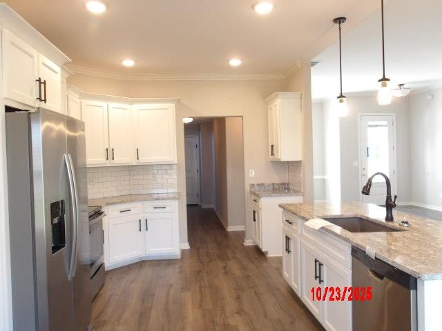 25 Daisy Way Somerville, TN 38068 - Photo 16 of 23 a kitchen with stainless steel appliances granite countertop a refrigerator a sink dishwasher a stove and a refrigerator