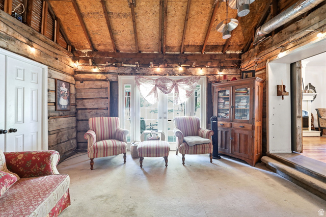 310 South 300 West Payson, UT 84651 - Photo 29 of 42 Rustic interior featuring exposed log walls, a vaulted wood-finish ceiling, and double French doors