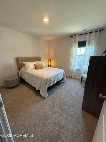 a bedroom with bed and window