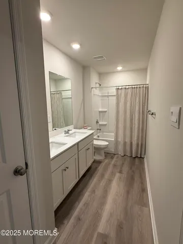a bathroom with a sink a mirror and a toilet