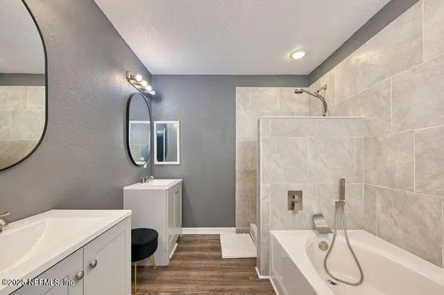 a bathroom with a sink a mirror and a shower