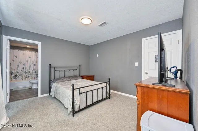 a bedroom with a bed and a dresser