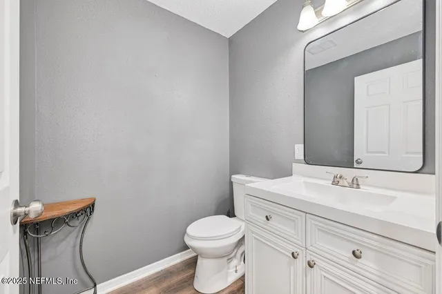 a bathroom with a sink mirror vanity and toilet