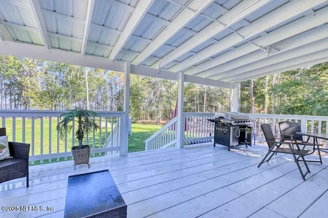 a view of a dining room with furniture large windows and wooden floor