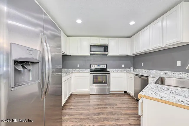a kitchen with a stove a sink and a refrigerator