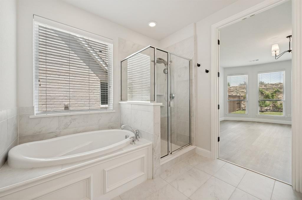 1000 Adair Road Prosper, TX 75078 - Photo 14 of 37 a white bath tub sitting next to a shower
