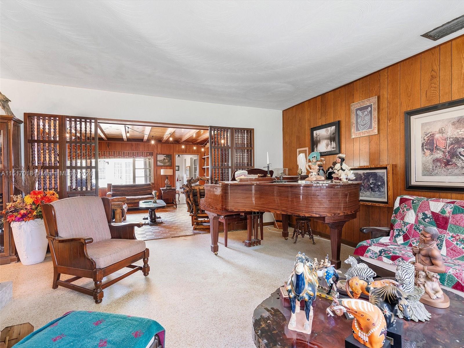 5901 Southwest 160th Avenue Southwest Ranches, FL 33331 - Photo 11 of 92 a living room with furniture a rug and a floor to ceiling window