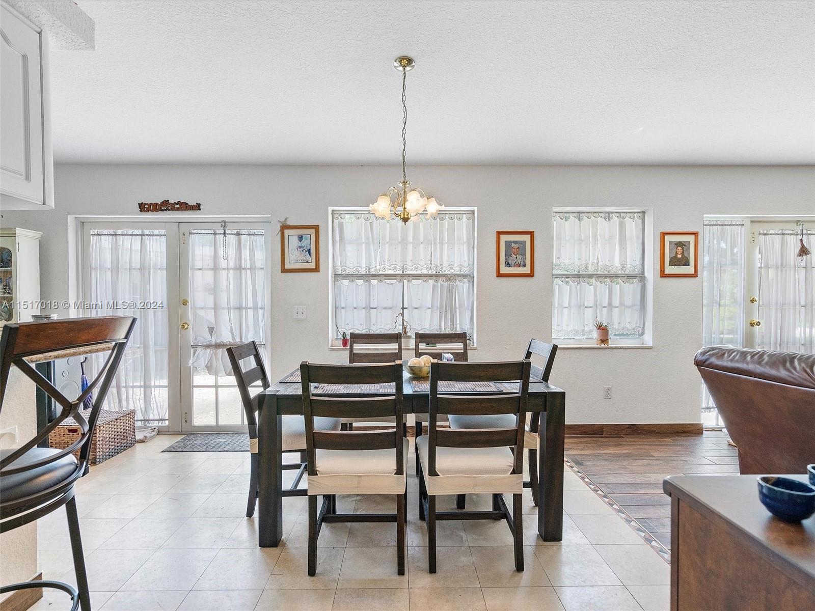 5901 Southwest 160th Avenue Southwest Ranches, FL 33331 - Photo 50 of 92 a view of a dining room with furniture window and wooden floor