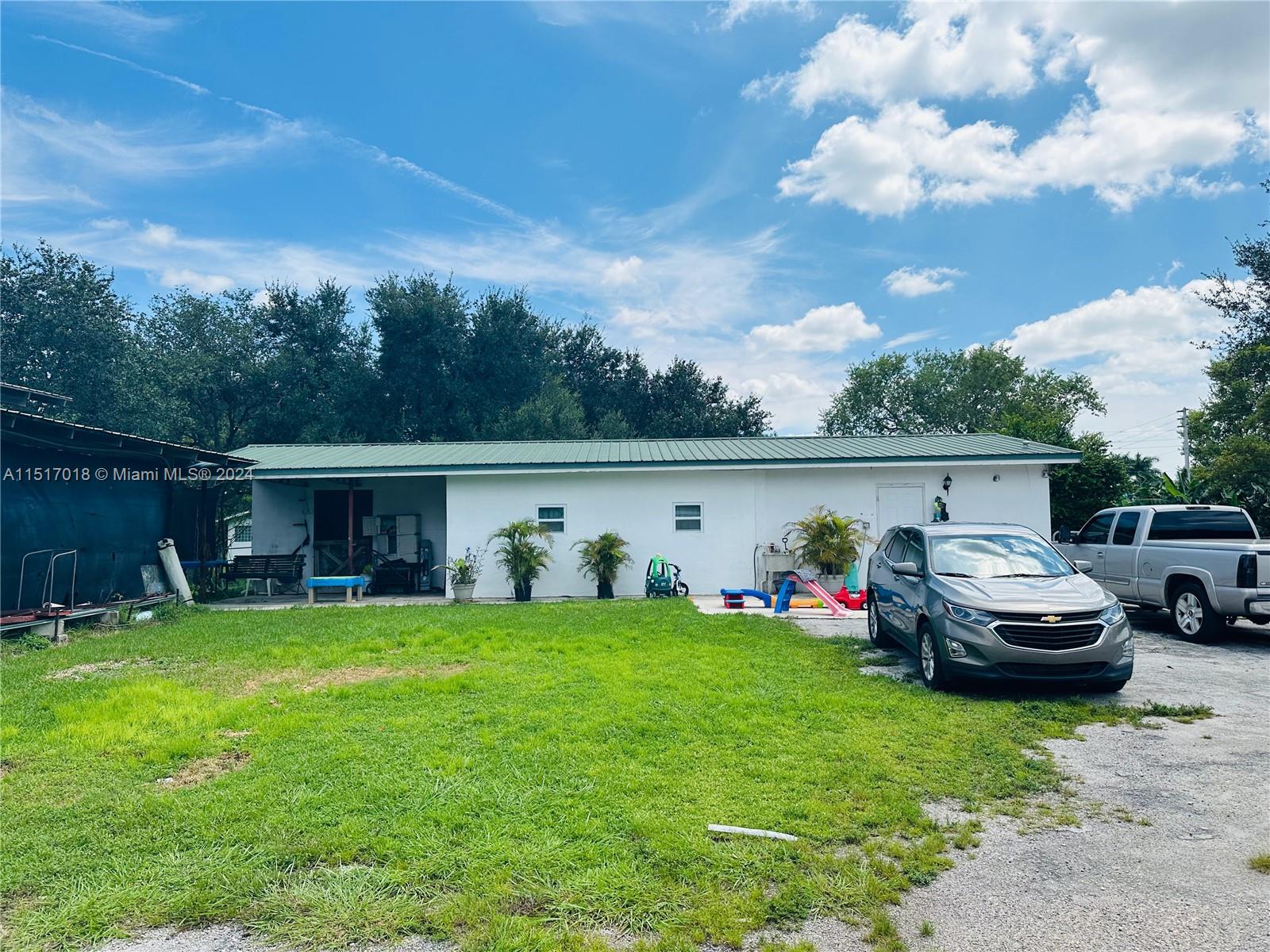 5901 Southwest 160th Avenue Southwest Ranches, FL 33331 - Photo 71 of 92 a view of back yard of house with outdoor seating and barbeque oven