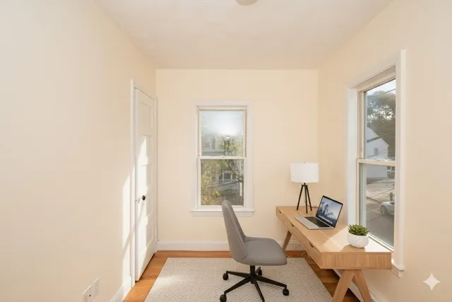 a workspace room with furniture and wooden floor