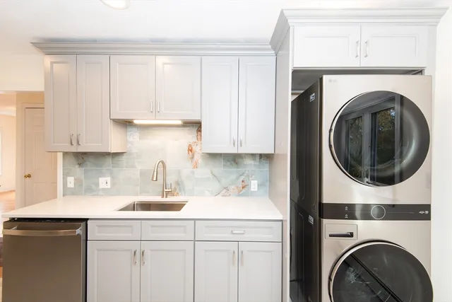 a kitchen with a sink and a washer dryer
