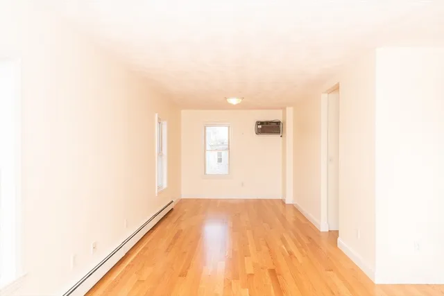 a view of a room with a white wall and a window
