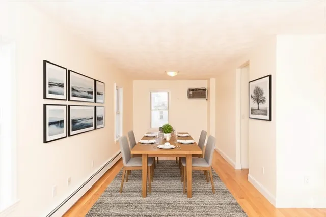 a dining room with furniture and window