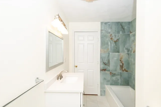 a bathroom with a bathtub and a sink