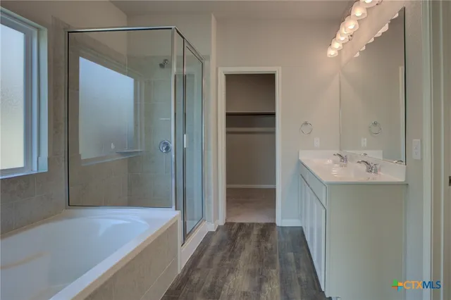 a bathroom with a tub sink and shower