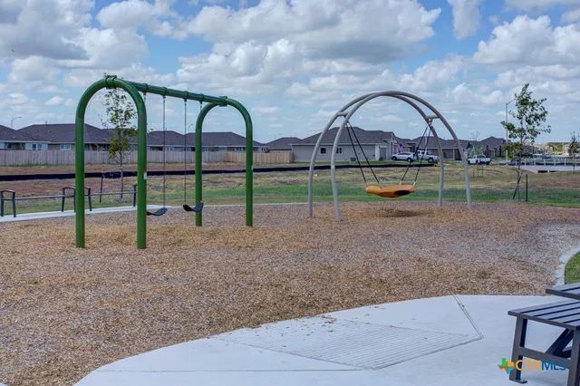 a view of house with a backyard