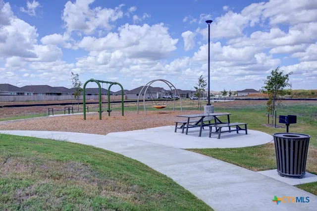 a view of a park with furniture