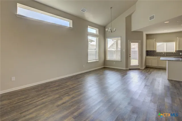 a view of a room with wooden floor and window