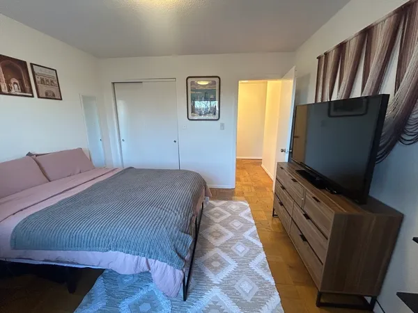 a bedroom with a bed and a flat screen tv