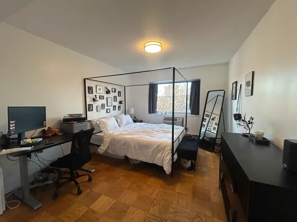 a bedroom with a bed a desk and chair