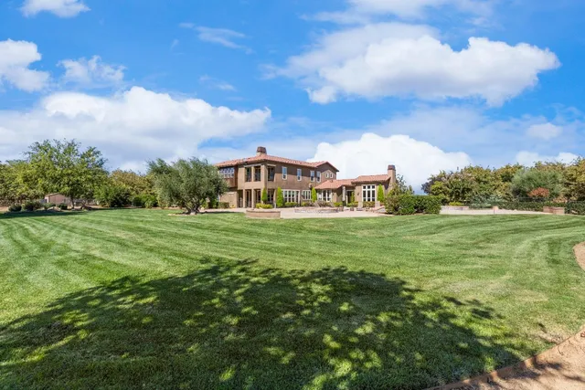 a view of staircase with lots of frames on wall and a large window