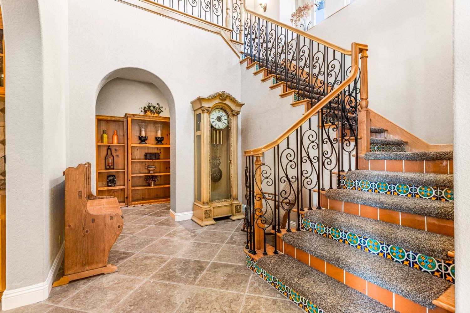 618 Elfers Road Patterson, CA 95363 - Photo 30 of 79 a view of staircase with lots of frames on wall and a large window
