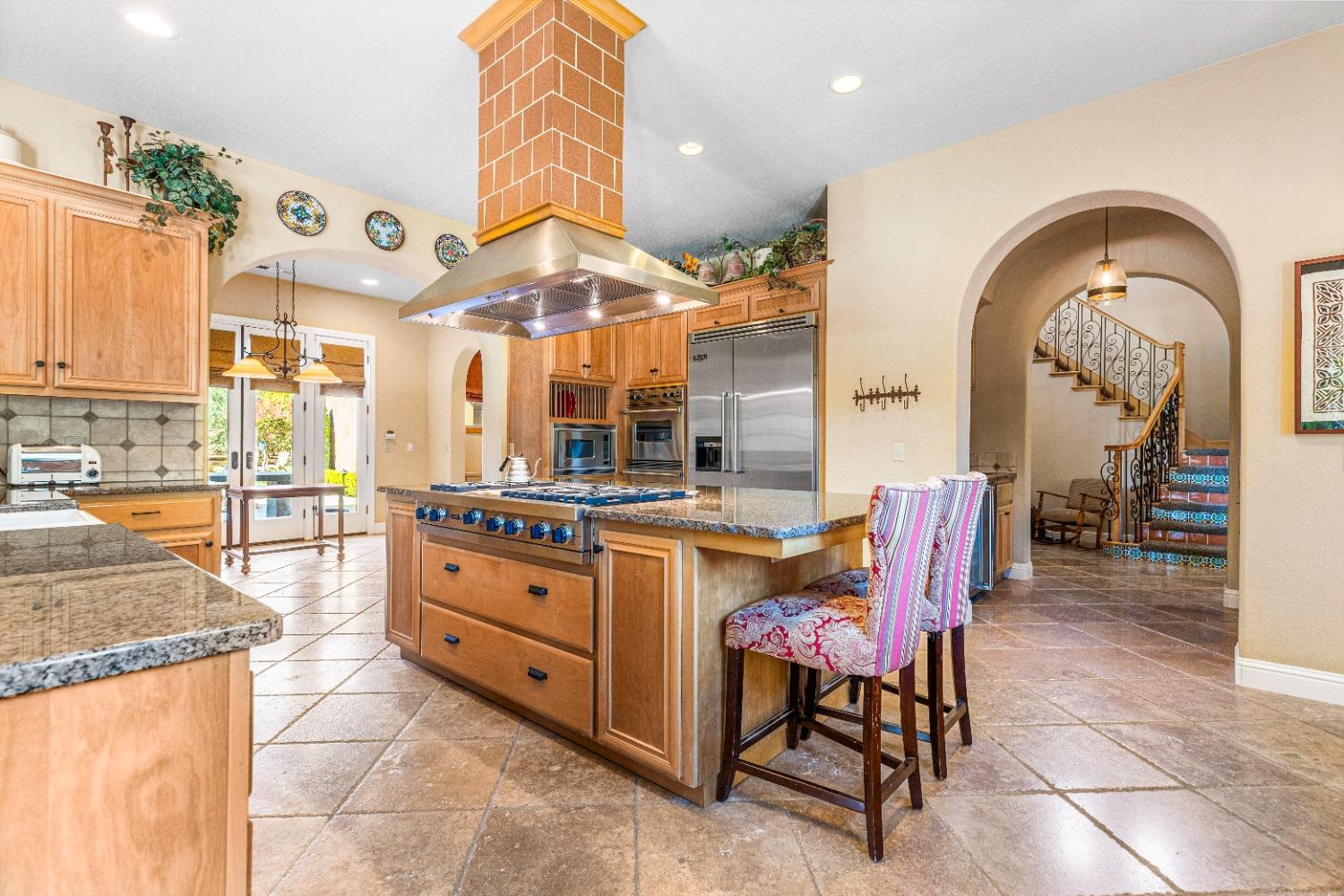 618 Elfers Road Patterson, CA 95363 - Photo 36 of 79 a large kitchen with stainless steel appliances granite countertop a stove a sink dishwasher and a dining table with the living room view