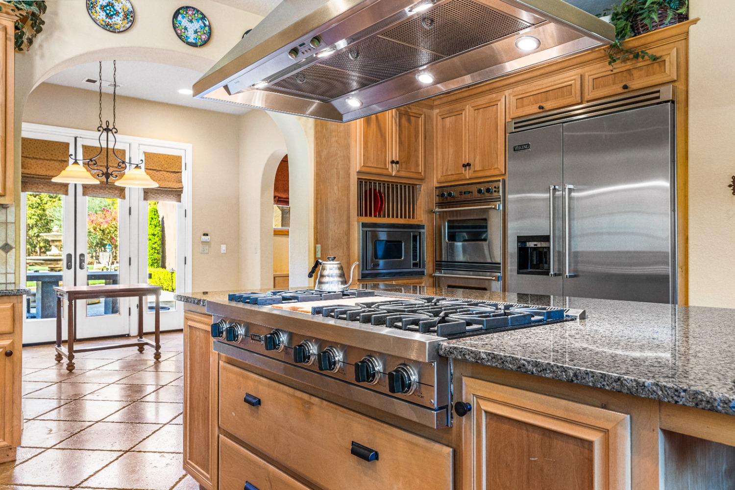 618 Elfers Road Patterson, CA 95363 - Photo 37 of 79 a kitchen with stainless steel appliances granite countertop a stove a sink and a refrigerator