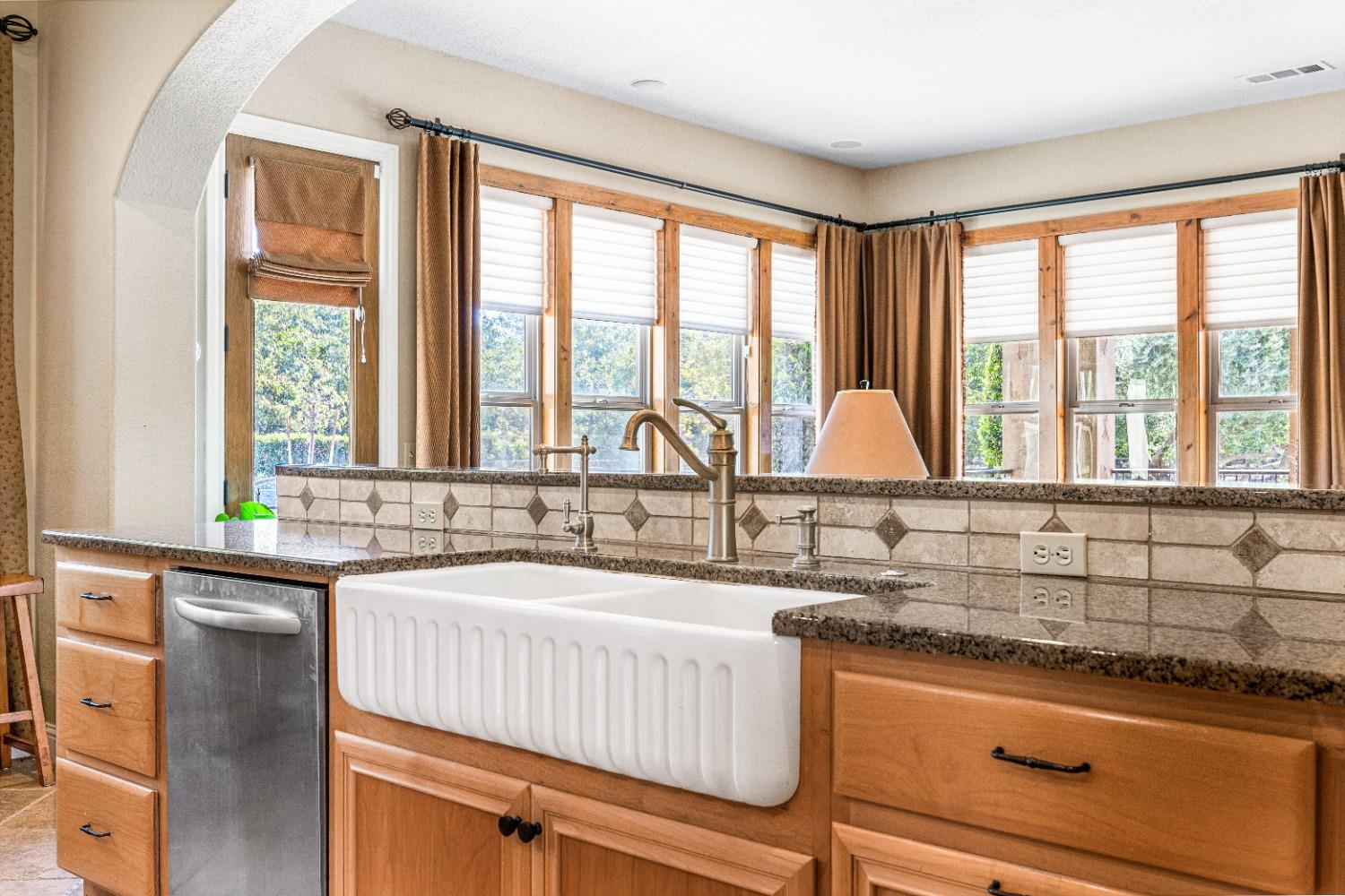 618 Elfers Road Patterson, CA 95363 - Photo 39 of 79 a kitchen with granite countertop a sink and a window