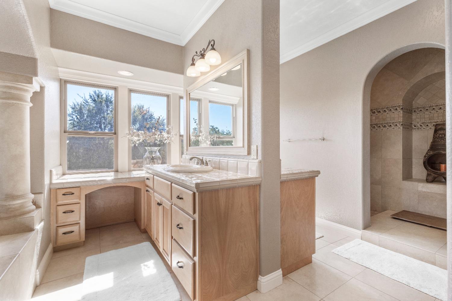 618 Elfers Road Patterson, CA 95363 - Photo 48 of 79 a spacious bathroom with a double vanity sink and a large mirror
