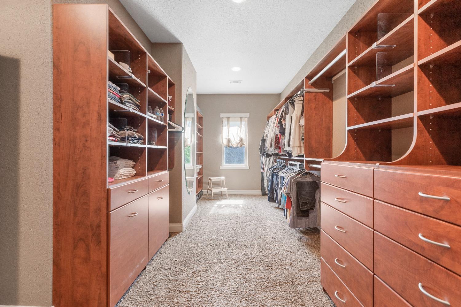 618 Elfers Road Patterson, CA 95363 - Photo 51 of 79 a view of walk in closet with clothes and shoes
